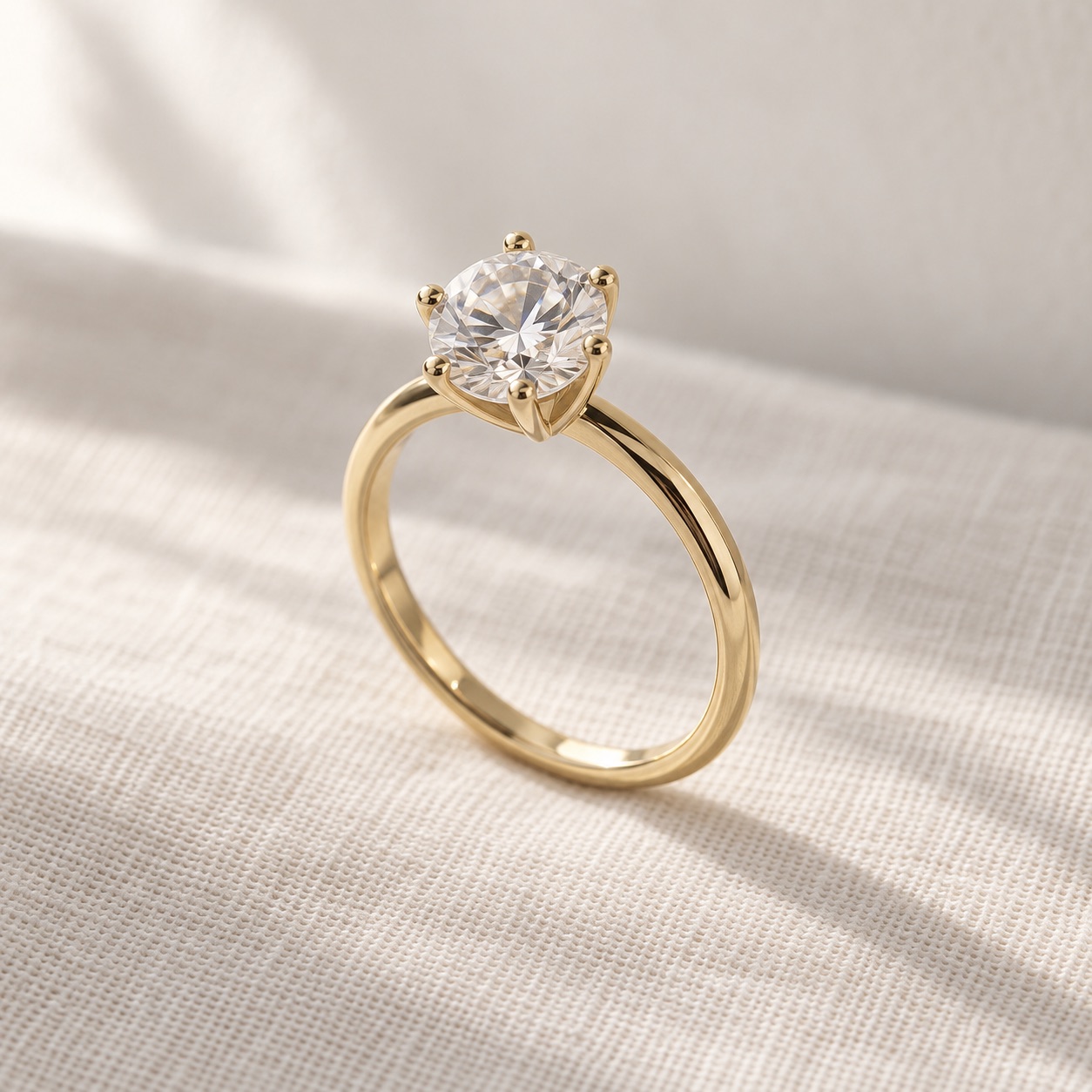 A round centre stone on a warm yellow-gold band. Simple lines keep the shape of the stone in focus.
